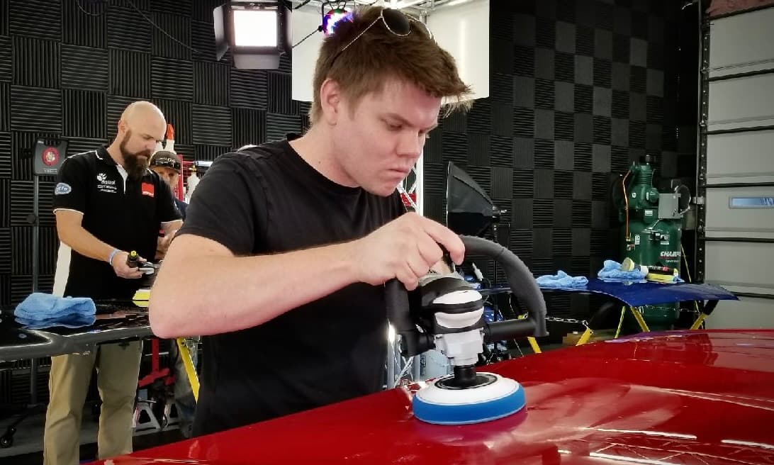Andrew polishing paint at a detailing event